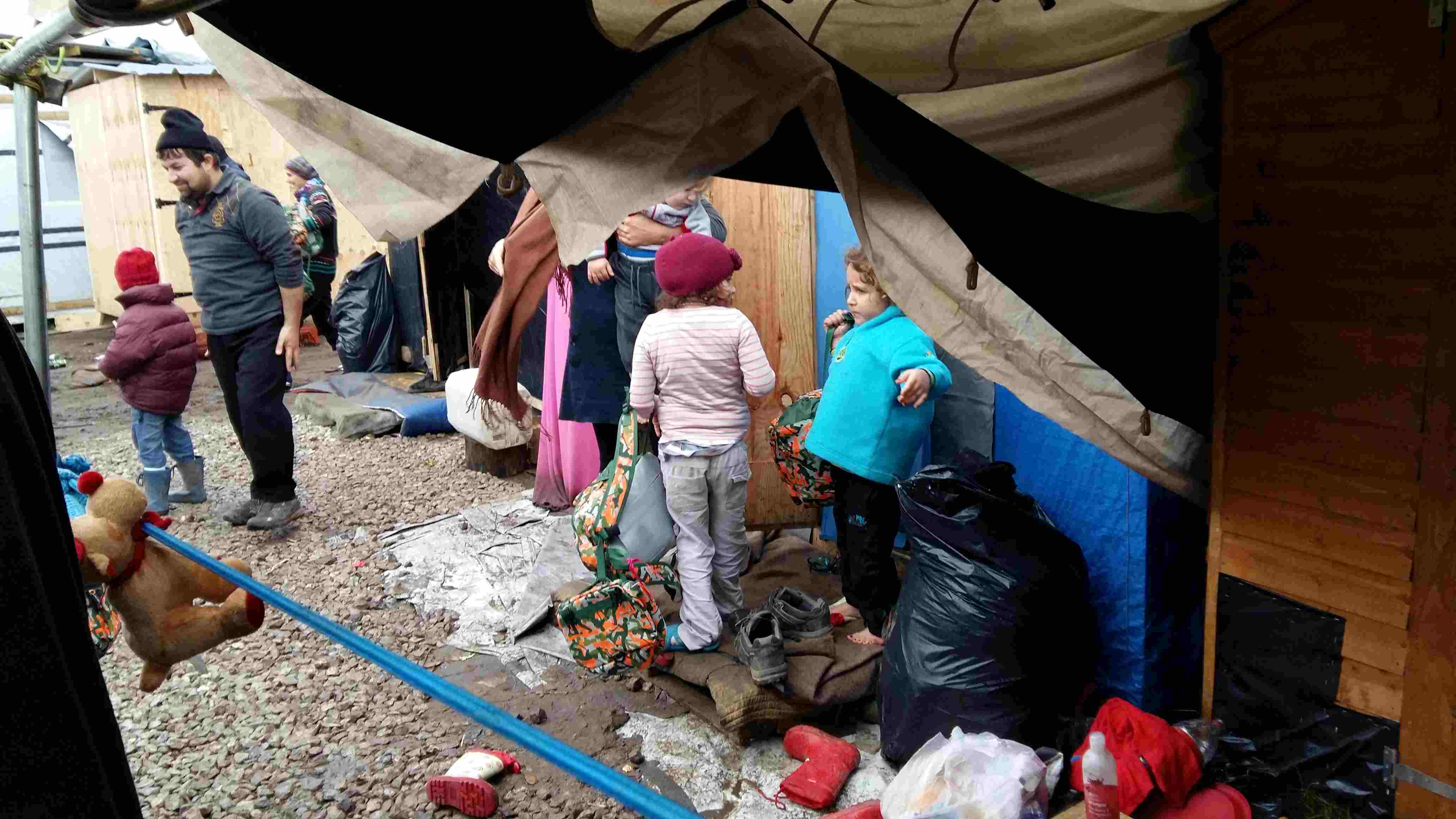Distributing the Christmas rucksacks to the people in
              the camp