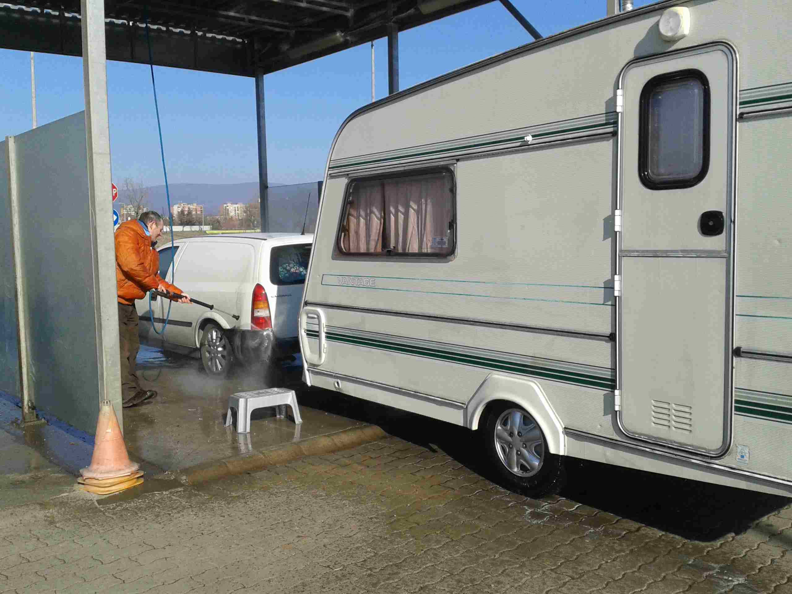 This shows Pastor Lajos washing the car and caravan
              down, before we present it to The Church in Sajsantpeter,
              Miskolsh, Hungary