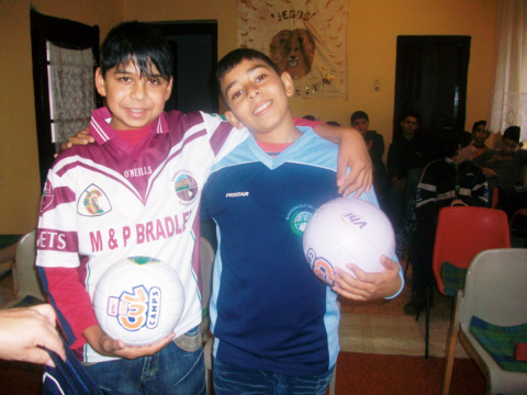 Dani and Zoltan show off their new football stripes, even though they are from different football clubs in Ireland