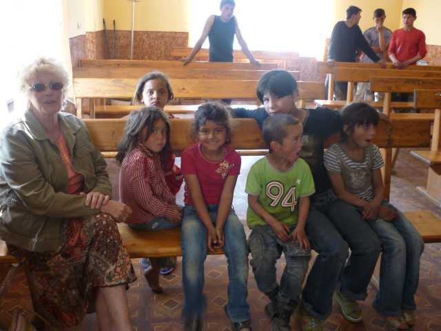 Sheila Hargreaves, from Wales, sitting on a bench in the Church in Homog, Ukraine